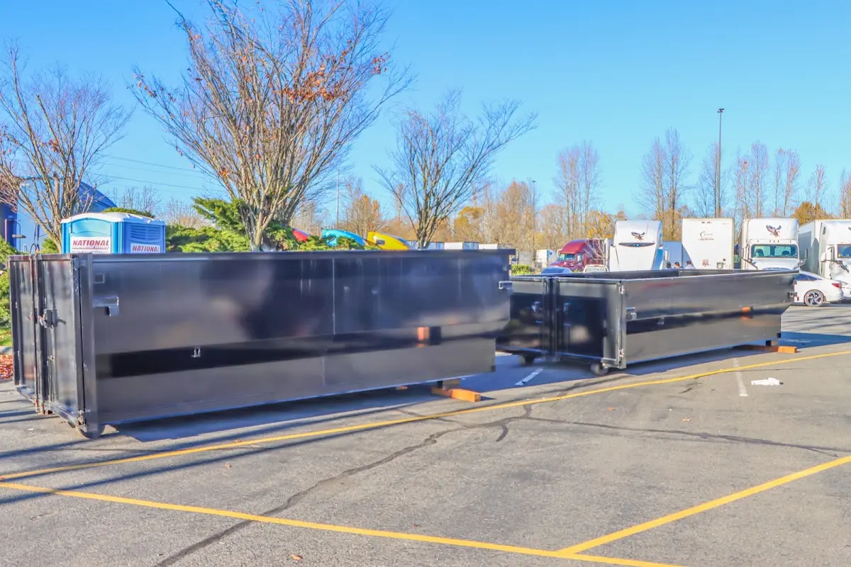 Professional dumpster rental service with roll-off container on residential driveway in Jamul